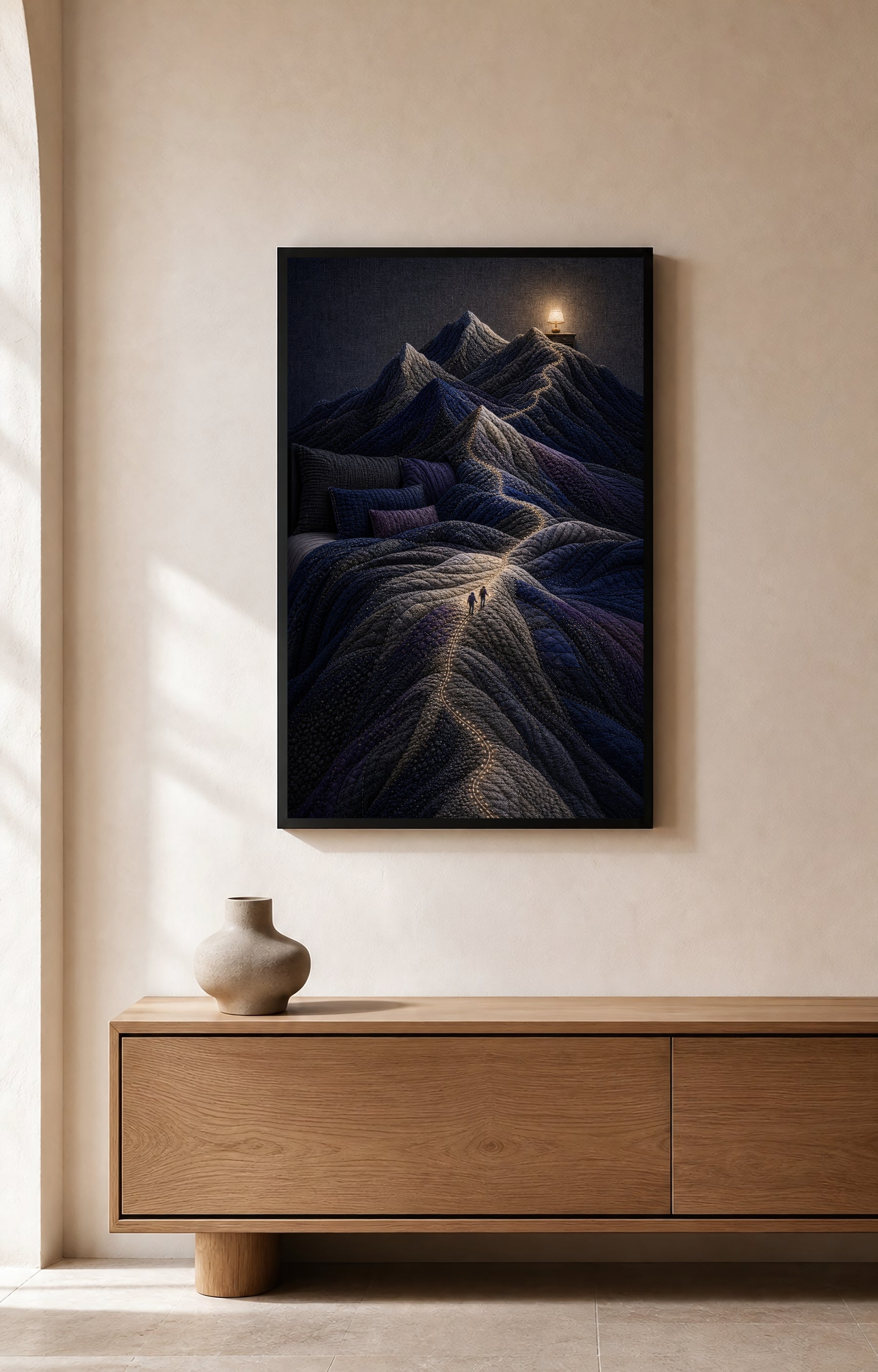 The Bed Became Mountains black-framed art print displayed above a light wood console